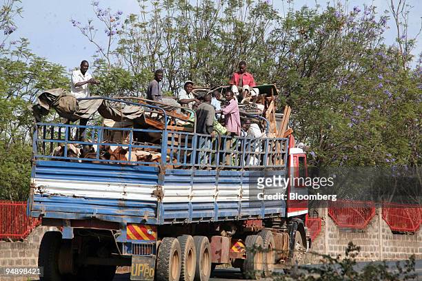 Displaced people ride in a truck with their belongings in Eldoret, Kenya, on Saturday, Feb. 16, 2008. As many as 400 people died in the violence in...