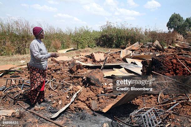 Lucy Wangui stands in the rubble of what was once the Assemblies of God church in Eldoret, Kenya, on Saturday, Feb. 16, 2008. As many as 400 people...