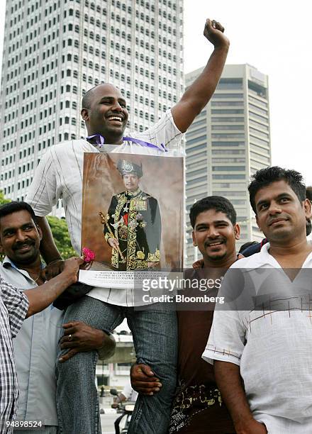 Ethnic Indian protesters carry a portrait of Mizan Zainal Abidin, the King of Malaysia, during a rally in Kuala Lumpur, Malaysia, on Saturday, Feb....