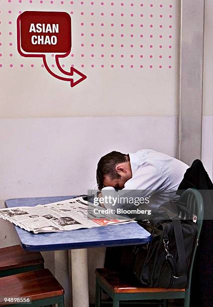 Stranded passenger Derek Simmons of Cincinnati, Ohio, takes a nap at Newark Liberty International Airport in Newark, New Jersey, U.S., on Friday,...