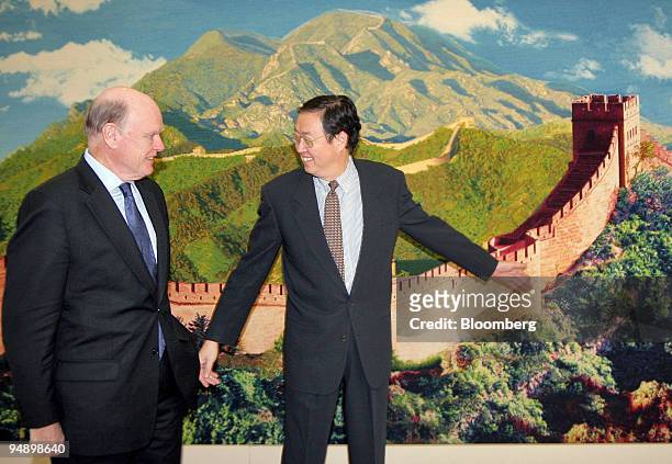 Visiting U.S. Treasury Secretary John Snow, left, is guided to his seat by Zhou Xiaochuan, the governor of the People's Bank of China, at the start...