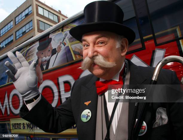 Man dressed as Mr. Monopoly from Hasbro Inc.'s popular Monopoly board game poses outside the Hasbro New York Toy Fair 2008 in New York, U.S., on...