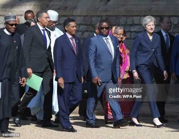British Prime Minister Theresa May walks with Commonwealth leaders as they arrive at Windsor Castle for a retreat on the final day of the...