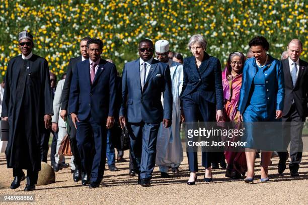 British Prime Minister Theresa May walks with commonwealth leaders as they arrive at Windsor Castle for a retreat on the final day of the...