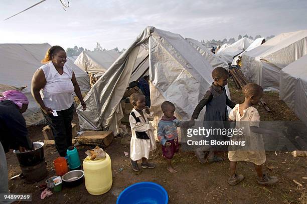 Janet Kamau survivor of the church burning and who was displaced by ethnic violence, stands outside her family's makeshift home at a refugee camp at...