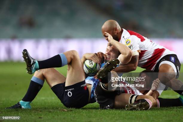 Bryce Hegarty of the Waratahs is tackled during the round 10 Super Rugby match between the Waratahs and the Lions at Allianz Stadium on April 20,...