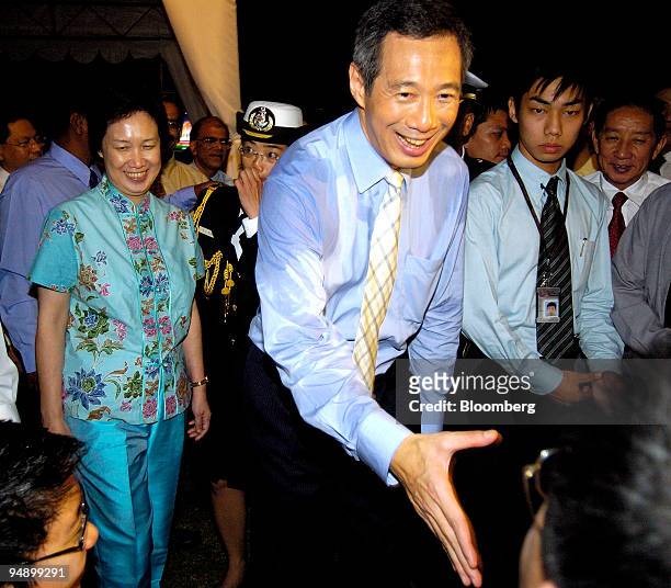 Newly appointed Singapore Prime Minister Lee Hsien Loong and his wife Ho Ching, behind on his right, meet well wishers after a swearing-in ceremony...