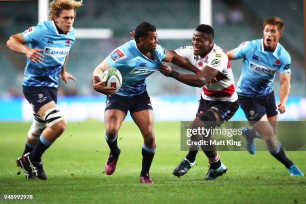 Kurtley Beale of the Waratahs takes on the defence during the round 10 Super Rugby match between the Waratahs and the Lions at Allianz Stadium on...