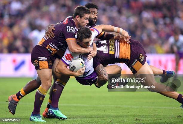 Ryan Hoffman of the Storm is tackled during the round seven NRL match between the Brisbane Broncos and the Melbourne Storm at Suncorp Stadium on...