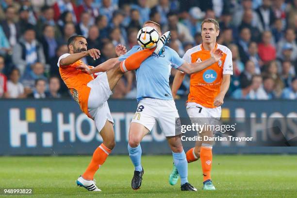 Fahid Ben Khalfallah of the Roar takes the balll close to Oliver Bozanic of Melbourne City face during the A-League Elimination Final match between...