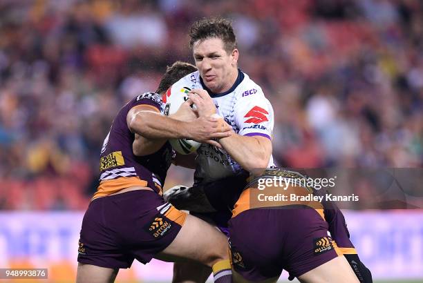 Ryan Hoffman of the Storm takes on the defence during the round seven NRL match between the Brisbane Broncos and the Melbourne Storm at Suncorp...