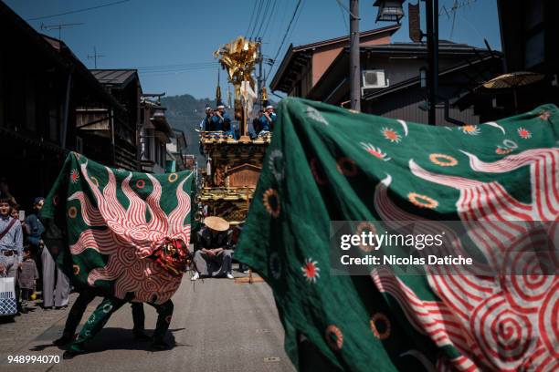 Lion's dances parade on the street on second day of Furukawa Masturis on April 20, 2018 in Hida, Japan. Furukawa Matsuri, an annual two-day festival,...