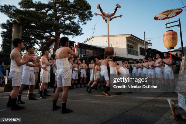 Half-naked festival-goer performs acrobatics for good luck during the first day of Furukawa Matsuri on April 19, 2018 in Hida, Japan. Furukawa...