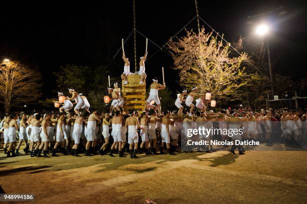Hundreds of men half-naked participate during Okoshi daiko, rousing big drum parade on first day of Furukawa Matsuri on April 19, 2018 in Hida,...