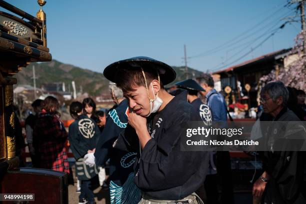 Furukawa Matsuri Festival-goer adjusts his hat before parade on April 19, 2018 in Hida, Japan. Furukawa Matsuri, an annual two-day festival, is...