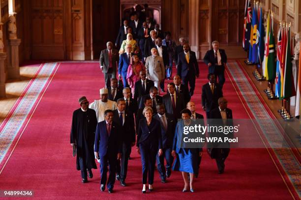 Seychelles' President Danny Faure, Britain's Prime Minister Theresa May and Commonwealth Secretary General Patricia Scotland lead other leaders down...