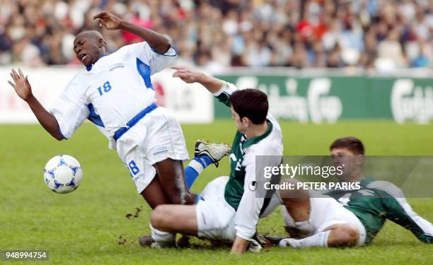 Saul Martinez of Honduras is fouled by Galic Marinko of Slovenia in the first game of the Carlsberg Cup soccer tournament in Hong Kong 12 February...