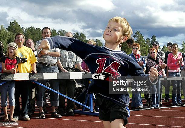 Young Finn takes his turn throwing in the Junior class during the sixth annual Mobile-Phone Throwing World championships in Savonlinna, Finland on...