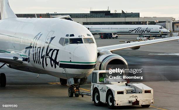 An Alaska Airlines jet is pushed back from a gate at Ted Stevens International Airport in Anchorage, Alaska, Friday, August 26, 2005.