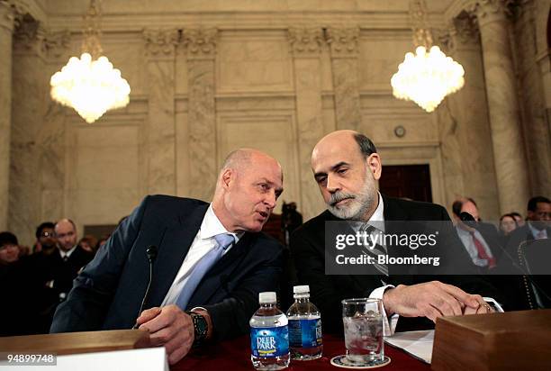 Henry Paulson, U.S. Treasury secretary, left, and Ben S. Bernanke, chairman of the U.S. Federal Reserve, confer during a Senate Banking Committee...