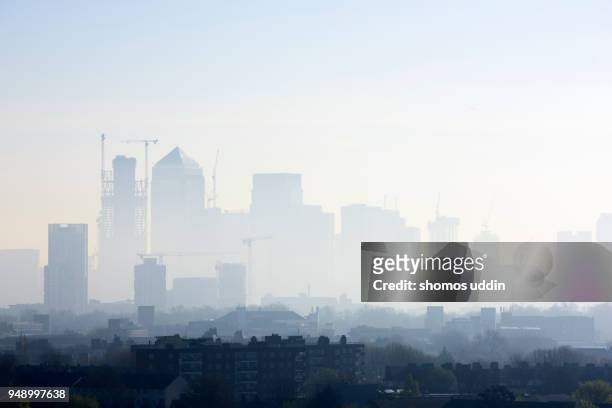 high angle cityscape of london skyline shrouded in smog - smog city stock pictures, royalty-free photos & images