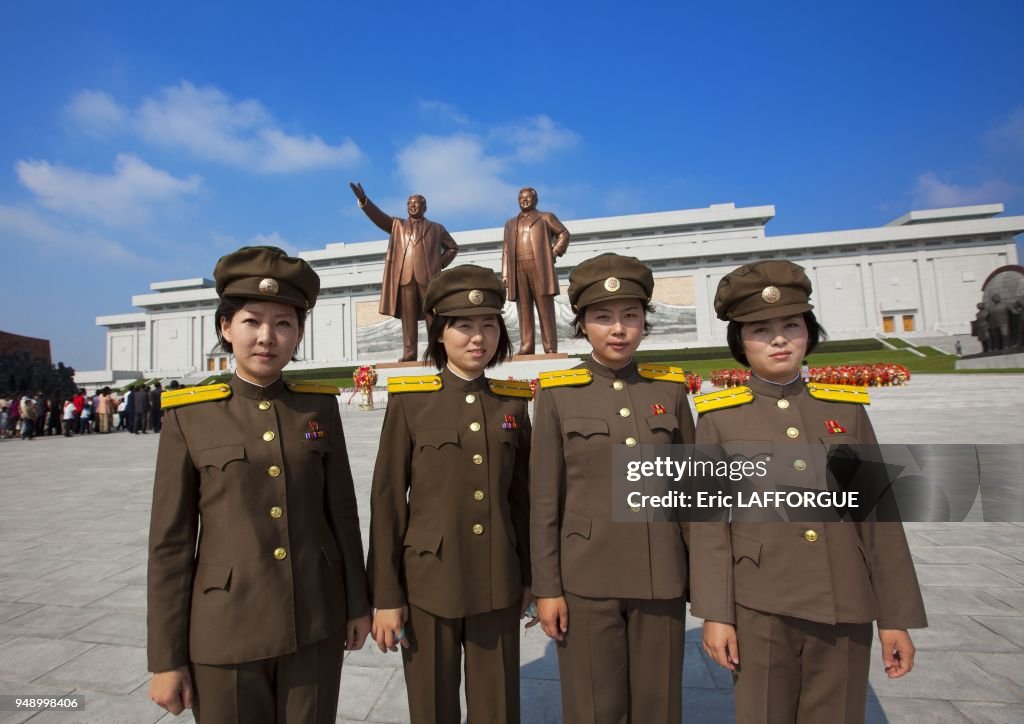 Pyongyang 95 Soldier girls paying respect to the two statues of the dear leaders ...