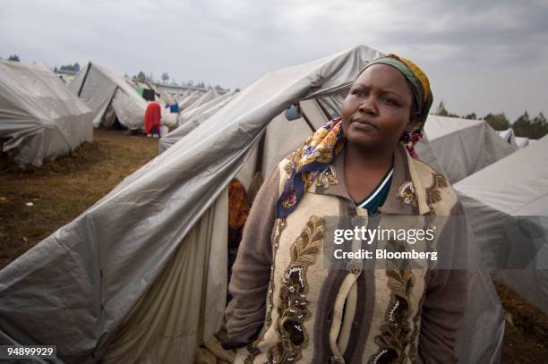 Janet Kamau survivor of the church burning and who was displaced by ethnic violence, stands outside a tent at a refugee camp at an agricultural show...