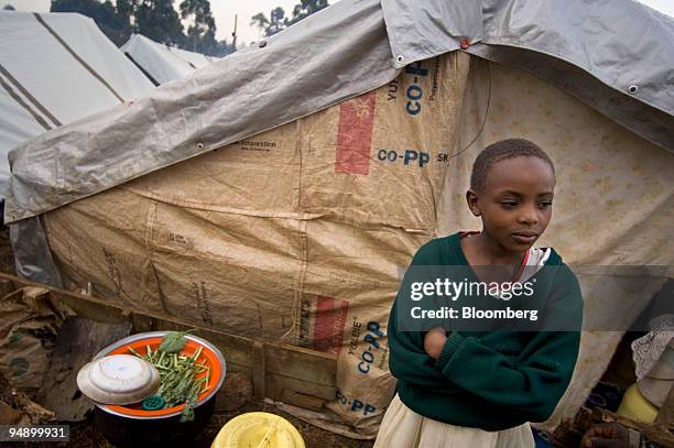 Hannah Njeri displaced by ethnic violence, stands outside her family's makeshift home in a refugee camp at an agricultural show grounds on the...