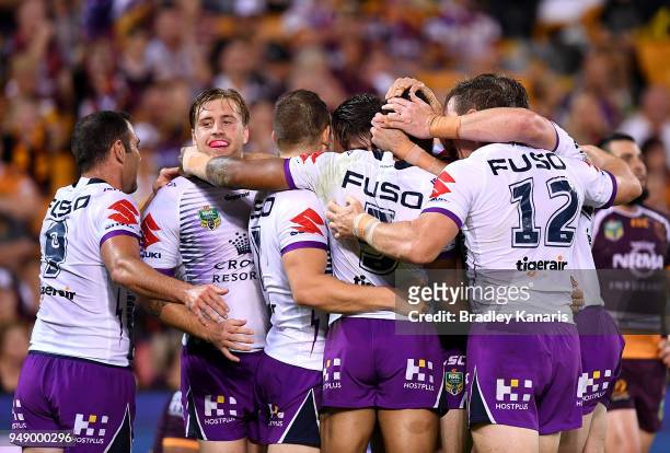 Melbourne Storm players celebrate a try by Billy Slater of the Storm during the round seven NRL match between the Brisbane Broncos and the Melbourne...
