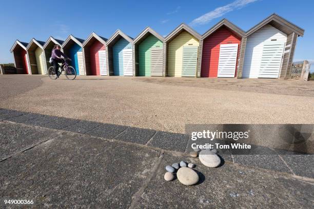 Pebble footprints left in front of coloured beach huts on April 20, 2018 in Blyth, United Kingdom. Britain continues to bask in the hottest weather...