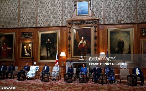 Britain's Prime Minister Theresa May makes a short statement in the Waterloo Chamber at Windsor Castle during a Commonwealth Heads of Government...