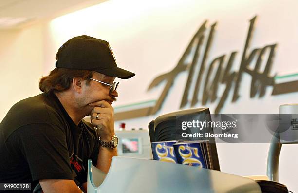 Hal Hendrickson stands at an Alaska Airlines ticket counter at Ted Stevens International Airport in Anchorage, Alaska as he purchases a pair of...