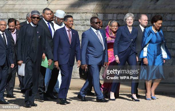 Prime Minister Theresa May and Commonwealth Secretary-General Patricia Scotland walk with Sierra Leone's President Julius Maada Bio and Seychelles'...