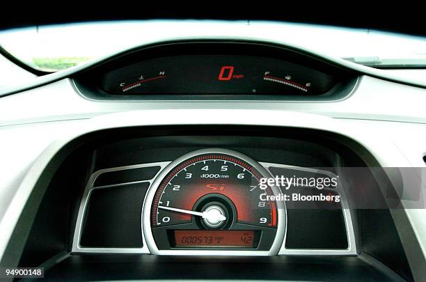 The digital speedometer and analog tachometer of a 2006 Honda Civic is pictured in Joliet, Illinois, August 25, 2005. Honda Motor Co. Is relying on a...