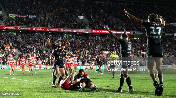 Warriors players celebrate the try of Isaiah Papali'i during the round seven NRL match between the New Zealand Warriors and the St George Illawarra...