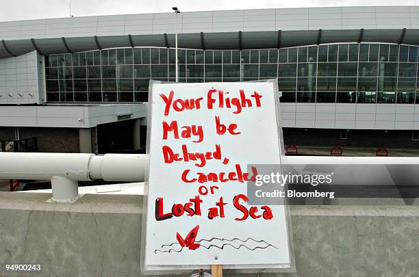 Sign leans on a railing near the picket line of Northwest Airlines mechanics outside the Ted Stevens Anchorage International Airport in Anchorage,...