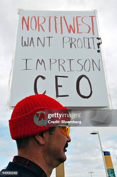 Year veteran Northwest Airlines mechanic Bruce Junes stands with a sign as he pickets outside the Ted Stevens Anchorage International Airport in...