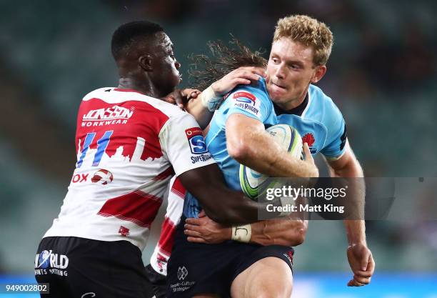 Bryce Hegarty of the Waratahs is tackled during the round 10 Super Rugby match between the Waratahs and the Lions at Allianz Stadium on April 20,...