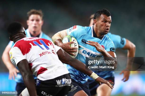 Kurtley Beale of the Waratahs takes on the defence during the round 10 Super Rugby match between the Waratahs and the Lions at Allianz Stadium on...