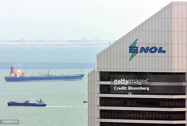 Neptune Orient Lines Ltd's headquarters building looms over vessels plying Singapore's port on Wednesday, August 4, 2004. Neptune Orient Lines Ltd.,...