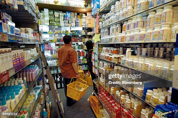 Shoppers browse through the aisles of medicines and health supplements at a pharmacy in Singapore, on Wednesday, Feb. 13, 2008. Singapore's...