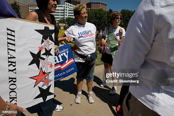 Hillary Clinton supporters, including Judy Cardamone, center, talk in Civic Center Park in Denver, Colorado, U.S., during an event running...