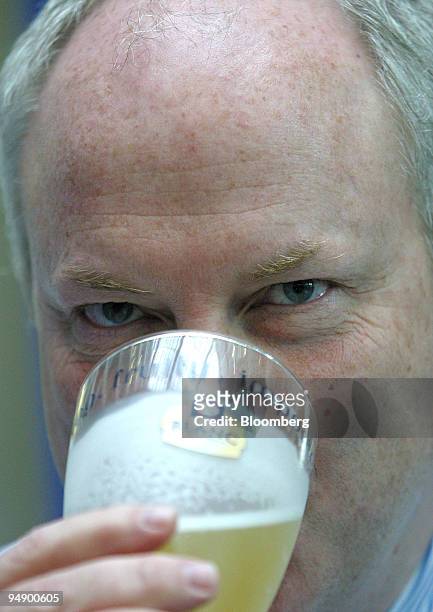 Tony Froggatt, chief executive of Scottish & Newcastle Plc samples one of their company products after a press conference in London, Tuesday, August...