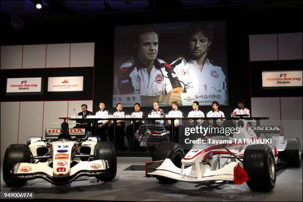 Honda Racing F1 team drivers Rubens Barrichello and Jenson Button are projected on a screen as they answer to reporter's question during a press...