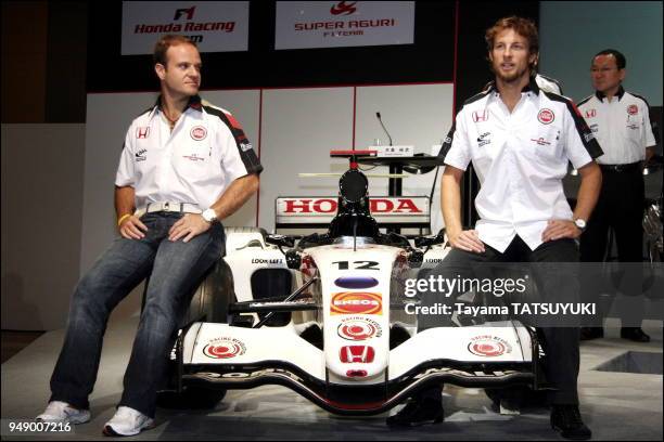 Honda Racing F1 team drivers Rubens Barrichello and Jenson Button pose for photographers during a press conference in Tokyo October 3 prior to this...