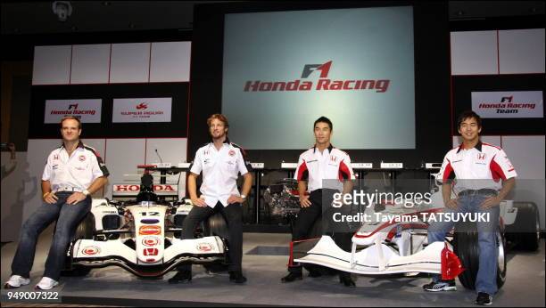 Honda Racing F1 team drivers Rubens Barrichello and Jenson Button pose with Super Aguri F1 team drivers Takuma Sato and Sakon Yamamoto during a press...