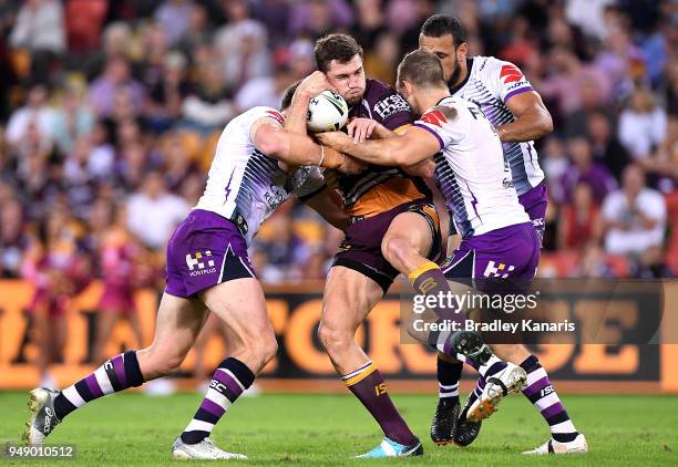 Corey Oates of the Broncos is tackled during the round seven NRL match between the Brisbane Broncos and the Melbourne Storm at Suncorp Stadium on...