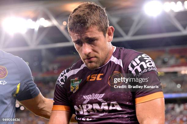 Andrew McCullough of the Broncos looks dejected as he is taken from the field injured during the round seven NRL match between the Brisbane Broncos...