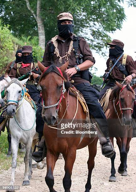 Subcomandante Marcos, center, of the National Liberation Army arrives on horseback for a meeting with members of the Dolores Hidalgo commune in the...