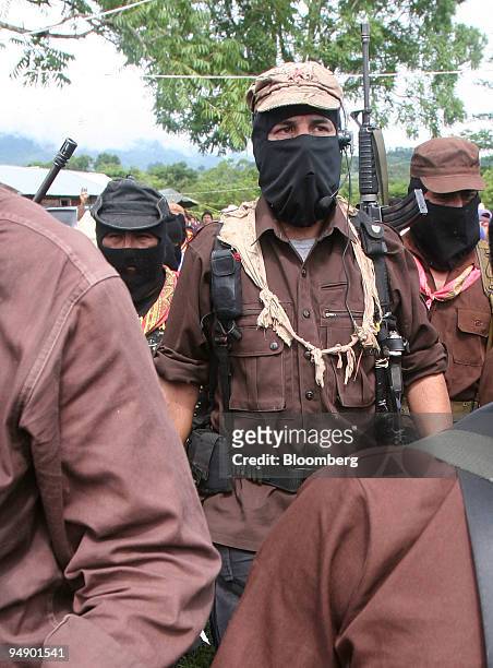 Subcomandante Marcos, center, of the National Liberation Army arrives for a meeting with members of the Dolores Hidalgo commune in the State of...